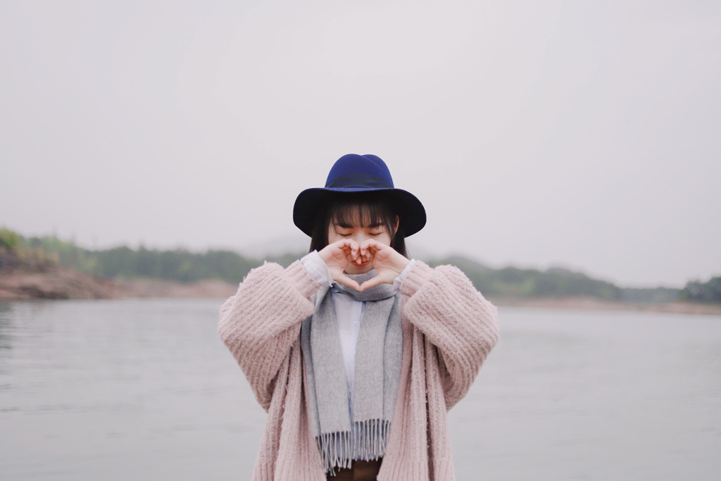 Stylish woman at Valentine's with heart pose